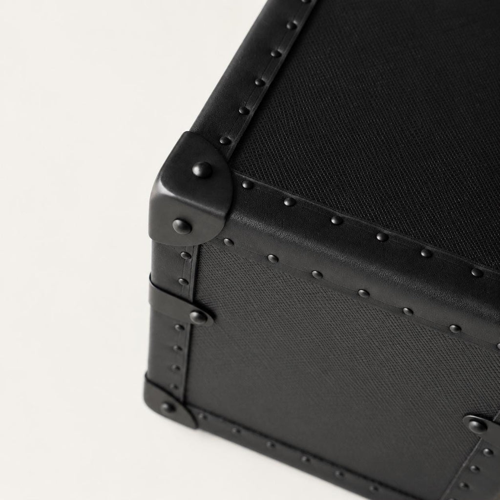 Close-up of black wooden jewelry trunk with stainless steel lock